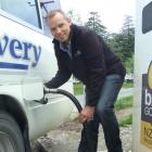 Kiwi Discovery general manager Tim Barke fills one of his buses with biodiesel at the Queenstown...