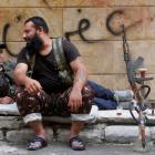 Kurdish Free Syrian Army fighters rest on a roadside in Ashrafieh, Aleppo. REUTERS/Muzaffar Salman