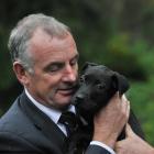 Labour's animal welfare spokesman Trevor Mallard meets 3-month-old Ebony at the Otago SPCA in...