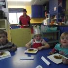 Lachlan Sheehan (3), Amber Malafu (4) and Ocean Sutherland (4) enjoy spaghetti bolognese for...