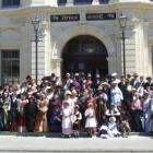 Ladies and gents attired in Victorian garb gathered on the steps of the opera house at midday...