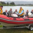Lake Dunstan Boat Club vice-commodore Roger Gibson (left) sits in the bow of the club's new...