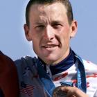 Lance Armstrong poses with his bronze medal after the men's Olympic individual time trial in...
