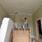 Landlady Fiona Partridge does some dusting in preparation for painting this week.