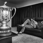 Laurie Mains relaxes at his home with the Bledisloe Cup. Photo from ODT files.