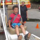 Learning the value of a seat belt during a simulation is Oto Higucha (7), of Queenstown. Photo by...