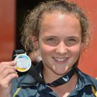 Legspinner Amelia Kerr  (14) displays her winner's medal after taking three wickets in her team's...