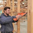 Leon Peirce (19) a building apprentice with Mark Fairweather Builder, works on a new house on...