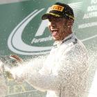 Lewis Hamilton sprays champagne on the podium after the Australian F1 Grand Prix at the Albert...