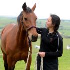 Lexie Elliott with her horse Jay in the paddock at home in Palmerston. Photo by Linda Robertson.