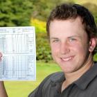 Liam Balneaves holds up his scorecard after shooting 62 to break Greg Turner's 23-year-old course...