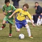 Liam Bell (L) of Mid Canterbury tackles Connor McLean of Central Otago.