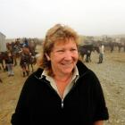 Linda Barnes, with the Tussock Creek light wagon trail, outside the historic ski hut on the Nevis...