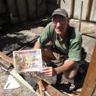 Lindsay Bellamy, of Bagley Builders, holds a 59-year-old book on the Ranfurly Shield found in a...