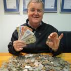 Lions Club of Queenstown member Simon Hayes, of Dalefield, holds old paper notes from countries...