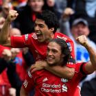 Liverpool's Andy Carroll (bottom) celebrates his goal against Everton with teammate Luis Suarez...