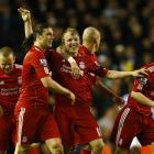 Liverpool's Dirk Kuyt, centre, is congratulated by team-mates after scoring a goal against...