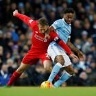 Liverpool's Lucas Leiva vies for the ball with Manchester City's Raheem Sterling. Photo: Reuters