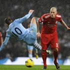 Liverpool's Martin Skrtel (R) challenges Manchester City's Edin Dzeko during their Premier League...