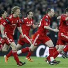 Liverpool's players react after winning on penalties against Cardiff City during their English...