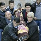 Locals carry a victim killed in air strikes to the morgue of a hospital in Uludere, of the Sirnak...
