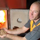 Logan Park High School property site manager Dave Penny with wood pellets for the school's boiler...