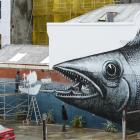 London  artist Phlegm (left) works on a mural on the former Rogan McIndoe building in Vogel St,...