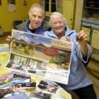 Cliff and Valerie Hall show the promotional material for the Queensland house they have won in a...