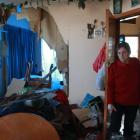 Louise Daley inspects the devastation where a car smashed into her Orwell St, Oamaru, home. Photo...