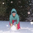 Lucy Sawers(8) of Alexandra builds a snowman. Photo Sarah Sawers