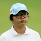 Lydia Ko Zealand watches a shot on the 18th hole during the weather-delayed first round of the...