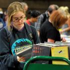 Mackenzie Reid browses  books in the Dunedin Public Libraries' book sale yesterday. Photo by...