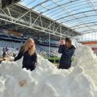 Maddie Kate Gibbons (21, right) tries to avoid being hit by a snowball thrown by Elise...