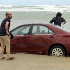 Mahmoud Helal (left), Ali Ibrahim and Hassan Almulla ponder how to recover their vehicles. ...
