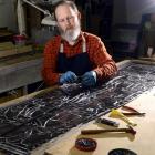 Maia stained-glass artist Peter Mackenzie puts the finishing touches to part of a larger work...
