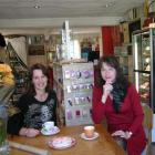 Making themselves comfortable in their new gift store are Little Brown House saleswoman Pip...