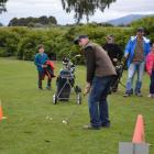 Malcolm Hancox prepares to  swing on the novelty golf course at the West Otago Health Centre's...