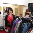 Manager Yvonne Shields prepares to welcome customers to the Inside Out clothing store, one of 10...