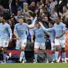 Manchester City players celebrate after going ahead against Tottenham during their Premier League...