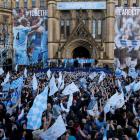 Manchester City players celebrate with their English Premier League trophy outside Manchester...