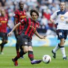 Manchester City's David Silva, centr, passes the ball against Bolton during their English Premier...