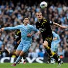 Manchester City's Samir Nasri (L) challenges Bolton Wanderers' David Wheater during their Premier...
