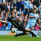 Manchester City's Sergio Aguero (R) shoots past Tottenham Hotspur's Jan Vertonghen to score his...