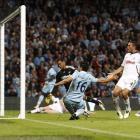 Manchester City striker Sergio Aguero, centre, scores against Swansea during their Premier League...