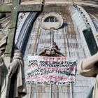Marcello Di Finizio stands on the dome of Saint Peter's Basilica holding a banner during a...