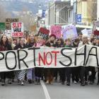 Marchers walk down George St on Saturday during the Dunedin Rape Crisis "Slutwalk" rally against...