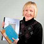 Margaret Pollock (59) with the original version and a digital version of her late father's diary...