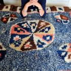 Margaret Woodhead, of Dunedin, with a rug made in the Shetland Islands by her great great...