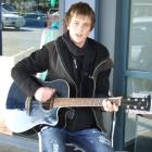 Mark MacDonald, of Maheno, was busking yesterday in the Gold Guitars "Freeze Ya Bits Off" busking...