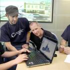 Mark McKenzie (left) learns how to render a building in 3D that could be uploaded to Google Earth...
